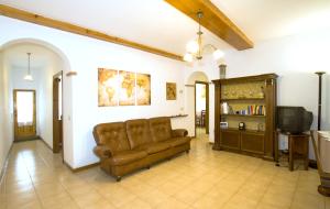 a living room with a couch and a tv at Cheap Apartment in The Old Village in Colle Val D'Elsa