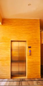 a wooden wall with a door in a building at Gobind Bhawan Heritage Hotel in Haridwār