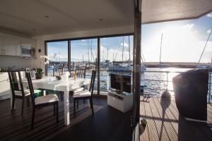 a dining room with a table and a view of the water at fewo1846 - Floatinghouse - Hausboot mit 2 Schlafzimmern in der Marina Sonwik in Flensburg