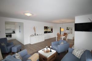 a living room with blue couches and a table at 1908 - Am Kurpark in Dahme