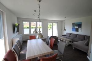 a living room with a table and a couch at 1360- Annina 1 in Dahme