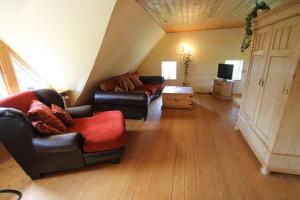 a living room with two couches and a tv at 1000 - Lüntsches Schloss Riepsdorf in Thomsdorf