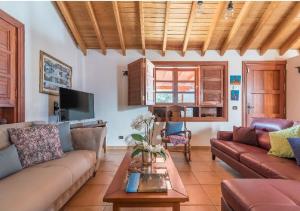 a living room with a couch and a table at Casa Agustín Pool 27 ºC in Fátaga