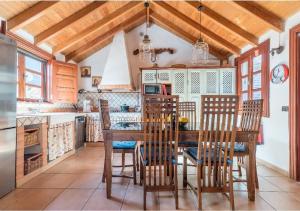 a kitchen with a wooden table and chairs at Casa Agustín Pool 27 ºC in Fátaga