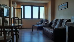 a living room with a couch and a table at Apartment Icovi 2 in Varna City