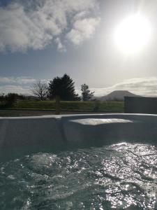 a swimming pool with water in the middle of it at Braeside Bothy in Dunvegan