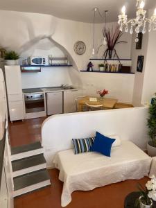 een kleine woonkamer met een bank en een keuken bij La Verde di Vernazza - Art Studio - AC&WiFi - Vernazzarentals in Vernazza
