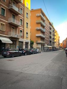 a city street with cars parked in front of buildings at Galè Apartment in Bologna