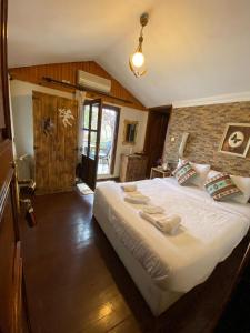 a bedroom with a large white bed in a room at Butik Hotel Maşukiye in Masukiye