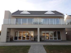 a large house with glass doors and windows at The Holy Hill Royal Alfred Marina in Port Alfred