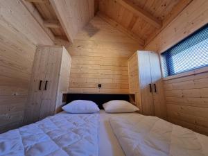 En eller flere senge i et værelse på Chalet met Sauna en Airconditioning