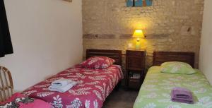 a bedroom with two beds and a lamp in it at les 2 Gîtes du Clos de la Vigne in Montreuil +40 photos