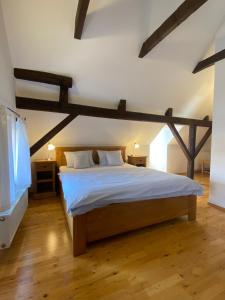 a bedroom with a large bed with wooden beams at Pension Wok in Český Krumlov
