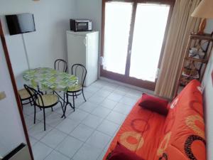 a living room with a table and a table and chairs at Studio Mezzanine, Residence avec piscine in Sète