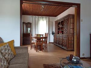 a living room with a couch and a table and chairs at Casa da Granja in Arouca