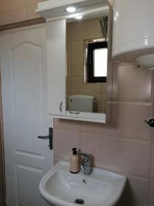 a bathroom with a sink and a mirror at Apartman Andrijana 1 in Soko Banja