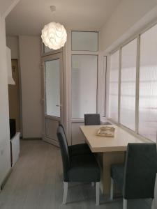 a dining room with a table and chairs and a light at Apartman Andrijana 1 in Soko Banja