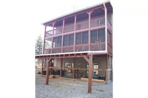 an image of a large house with large windows at Eagle Mountain River Retreat in Ellijay