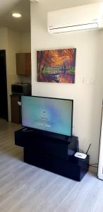 a flat screen tv sitting on a black stand in a room at Studio Anastasia in Limassol
