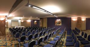 a conference room with chairs and a podium in it at Maritim Antonine Hotel & Spa in Mellieħa