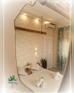 a mirror reflection of a bed in a room at Made in Sicily Santa Tecla in Acireale +130 photos