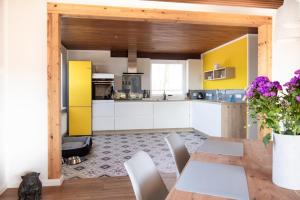 a kitchen with a dining table and a yellow refrigerator at Elli´s Hus in Loit