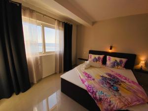 a bedroom with a bed with a large window at Apartment Mare in Rab