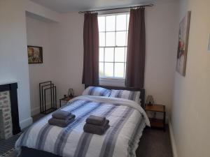 a bedroom with a bed with two towels on it at Eastgate Hideaway - central, luxury apartment on Chester's historic rows in Chester
