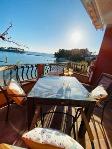 a table and chairs on a balcony with a view of the water at Apartment Mare in Rab