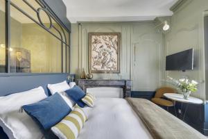 a bedroom with a large bed with a blue headboard at LE CELESTINE - Centre Historique - in Rennes