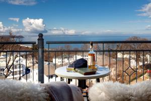 a bottle of wine sitting on a table on a balcony at Vju Hotel Rügen in Göhren