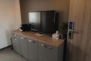 a large flat screen tv sitting on top of a cabinet at Family Fewo Sibiu in Sibiu