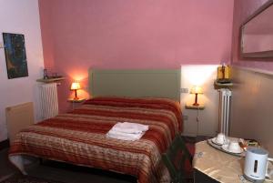 Postel nebo postele na pokoji v ubytování La Rocca delle Pigne