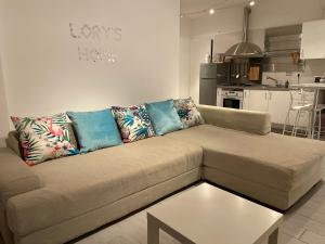 a living room with a couch and a kitchen at Bari Lory’s Home in Bari +37 photos