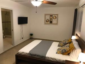 A bed or beds in a room at Punta Cana Apartment and scooter for free