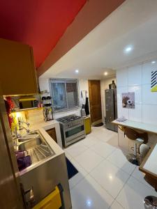 a kitchen with a sink and a stove top oven at Homestay Appartement 2 chambres in Yaoundé
