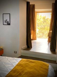 a bedroom with a bed and a large window at Santafe' in Vietri