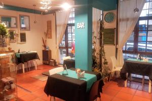 a restaurant with tables and chairs in a room at Hostel & Spa Mediterránea in Córdoba