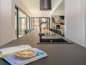 a kitchen with a sink and a book on a counter at Cà Veia in Vrbnik