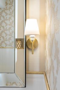 a bathroom with a lamp and a glass shower at BE IN GDANSK Apartments - DŁUGIE OGRODY in Gdańsk