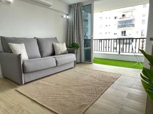a living room with a couch and a balcony at Style & Sea FREEWIFI in Los Cristianos