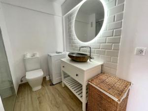 a bathroom with a sink and a toilet and a mirror at Style & Sea FREEWIFI in Los Cristianos +11 photos