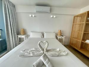 a bed with two towels in the shape of a heart at Style & Sea FREEWIFI in Los Cristianos