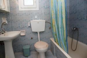 a bathroom with a toilet and a sink at Sea La Vie Apartment Koroni in Koroni