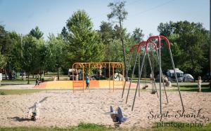 a playground in a park with people playing at Bonanza Camping Resort in Wisconsin Dells