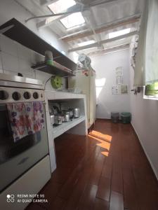 a kitchen with a white stove and a wooden floor at Hogar COLONIAL in Bogotá