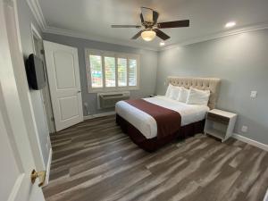 a bedroom with a bed and a ceiling fan at Lone Oak Lodge in Monterey