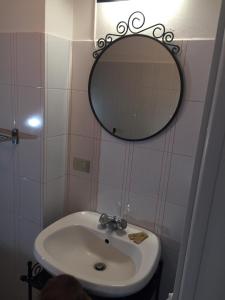 a bathroom with a sink and a mirror on the wall at Marta's house in Prebernardo