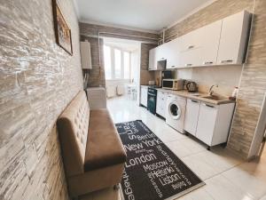 a living room with a couch and a kitchen at Luxury Sky Apartment in Chişinău
