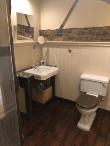 a bathroom with a toilet and a sink at Lane House Farm in Todmorden